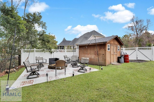 view of yard with a fire pit, a patio area, and a storage shed