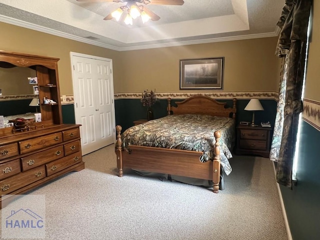 189 Sooner Dr, Jesup, GA 31545 - carpeted bedroom featuring a tray ceiling, crown molding, ceiling fan, and a closet