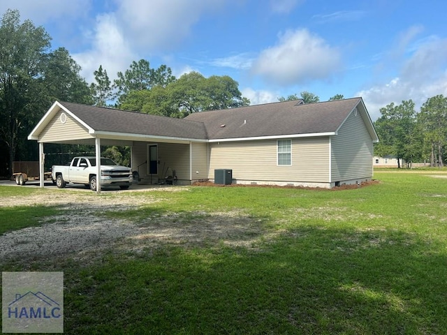 189 Sooner Dr, Jesup, GA 31545 - rear view of property with an attached carport, dirt driveway, and a yard