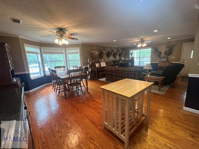 189 Sooner Dr, Jesup, GA 31545 - dining room with ceiling fan, ornamental molding, wood finished floors, a textured ceiling, and baseboards