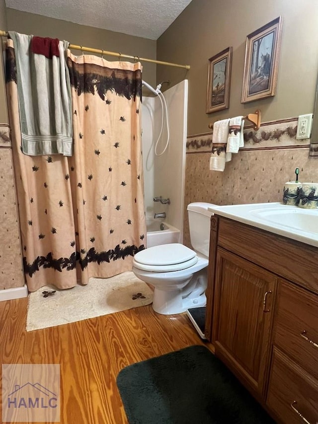 189 Sooner Dr, Jesup, GA 31545 - bathroom featuring vanity, toilet, shower / tub combo, wainscoting, and a textured ceiling