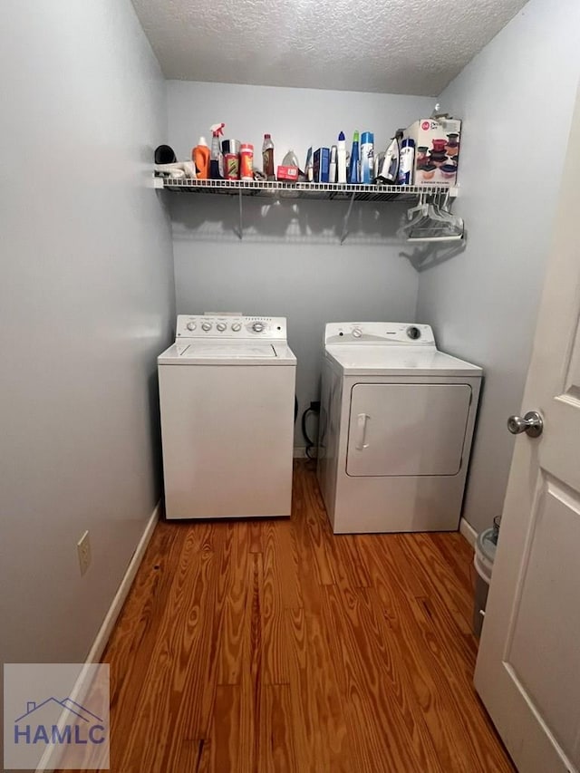 189 Sooner Dr, Jesup, GA 31545 - washroom with washing machine and dryer, wood finished floors, a textured ceiling, and baseboards