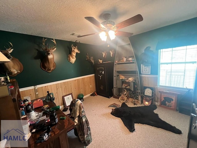 189 Sooner Dr, Jesup, GA 31545 - bedroom with a wainscoted wall, wood walls, a textured ceiling, carpet flooring, and a ceiling fan