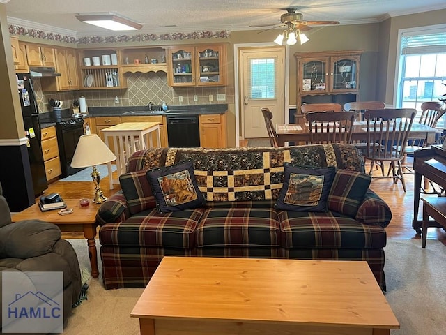 189 Sooner Dr, Jesup, GA 31545 - living room featuring ornamental molding, ceiling fan, and light carpet
