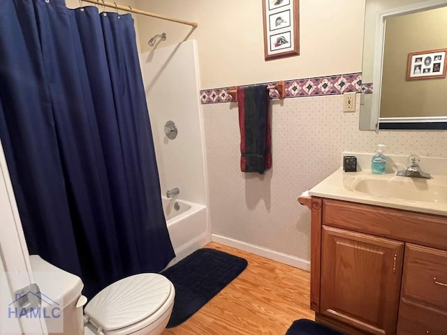 189 Sooner Dr, Jesup, GA 31545 - full bath with toilet, vanity, wood finished floors, shower / bath combination with curtain, and baseboards