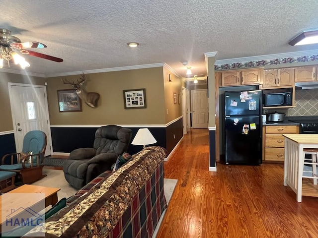 189 Sooner Dr, Jesup, GA 31545 - kitchen with black appliances, under cabinet range hood, ceiling fan, dark wood-style flooring, and a textured ceiling