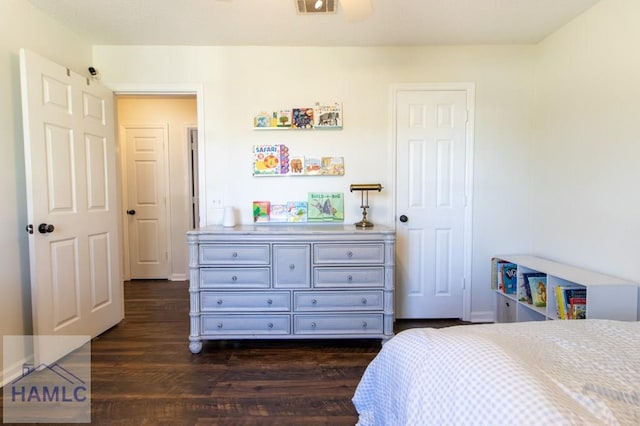 bedroom with dark wood-style flooring and visible vents