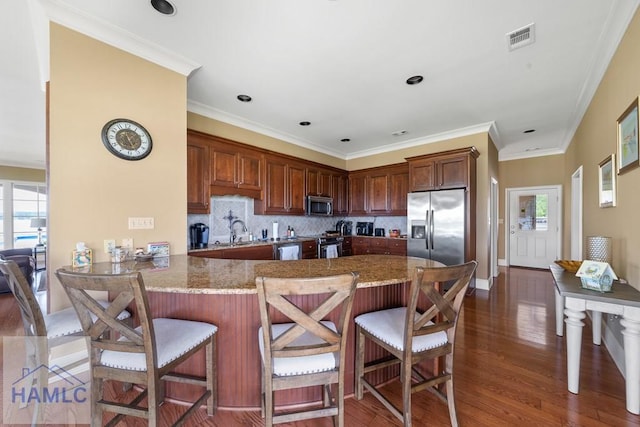 745 Chickasaw Trl, Sparta, GA 31087 - kitchen featuring appliances with stainless steel finishes, wood finished floors, healthy amount of natural light, and crown molding