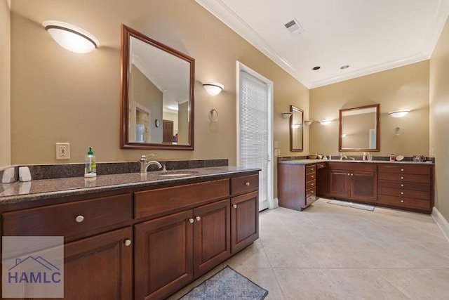 745 Chickasaw Trl, Sparta, GA 31087 - bathroom featuring crown molding, two vanities, tile patterned flooring, and baseboards