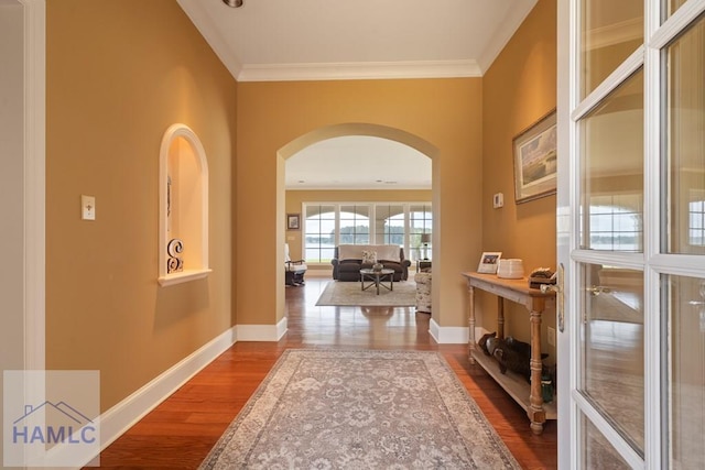 745 Chickasaw Trl, Sparta, GA 31087 - hallway featuring arched walkways, wood finished floors, baseboards, and crown molding