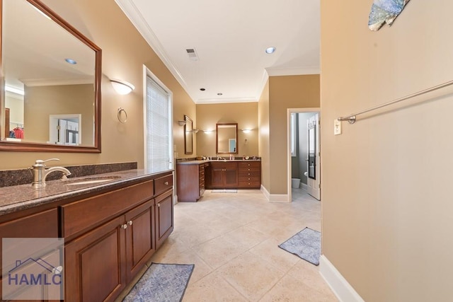 745 Chickasaw Trl, Sparta, GA 31087 - bathroom with crown molding, two vanities, baseboards, tile patterned flooring, and recessed lighting