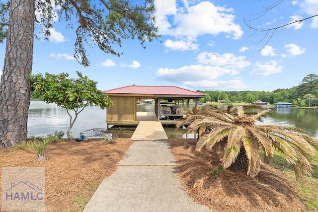 745 Chickasaw Trl, Sparta, GA 31087 - view of front of property featuring boat lift, a boat dock, a water view, and metal roof