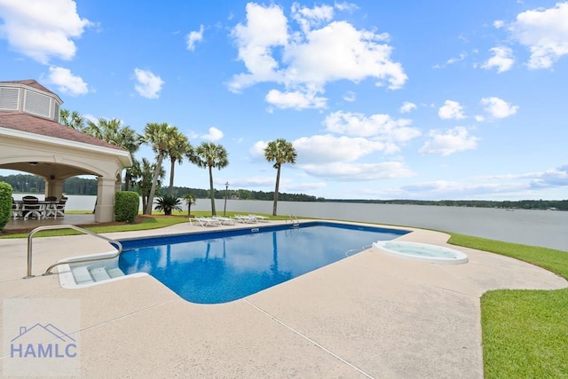 745 Chickasaw Trl, Sparta, GA 31087 - view of pool featuring a patio, a water view, and a pool with connected hot tub