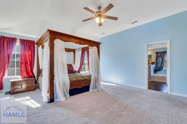 unfurnished bedroom featuring carpet floors, a ceiling fan, baseboards, lofted ceiling, and visible vents