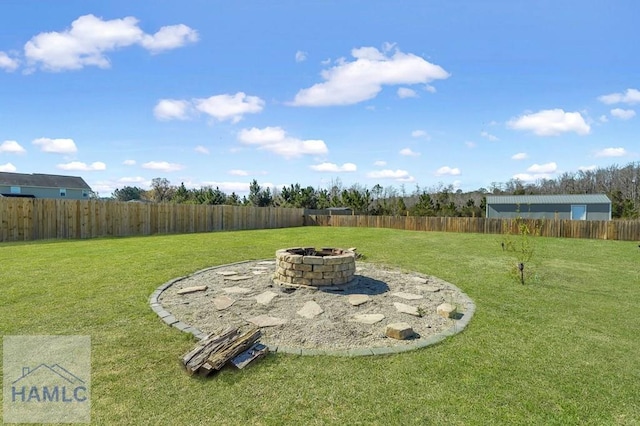view of yard with a fenced backyard and an outdoor fire pit