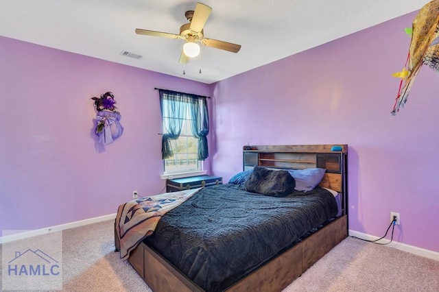 carpeted bedroom with visible vents, a ceiling fan, and baseboards