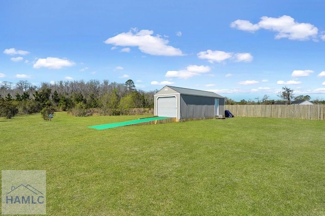 view of yard featuring fence and an outdoor structure