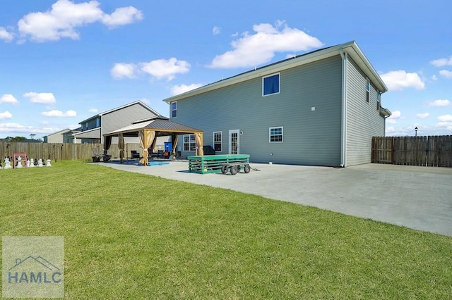 rear view of house with a lawn, a patio, a gazebo, and fence