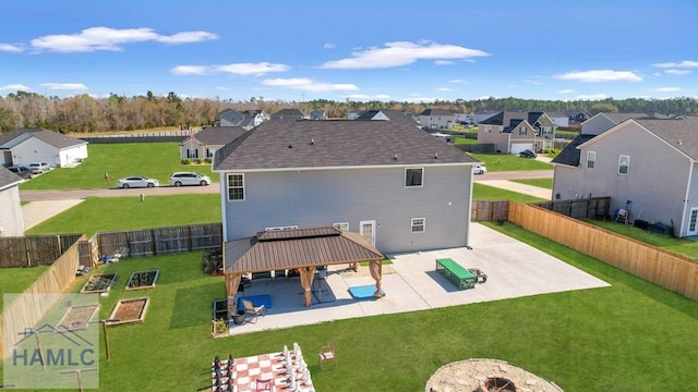 back of property with a gazebo, a fenced backyard, a patio area, and a residential view