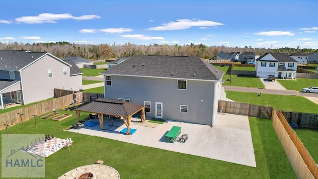 back of house featuring a residential view, a gazebo, a patio area, and a fenced backyard