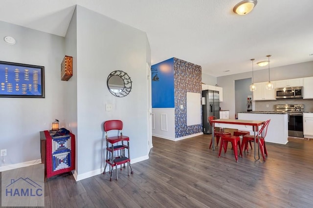 dining space featuring baseboards and dark wood-style floors