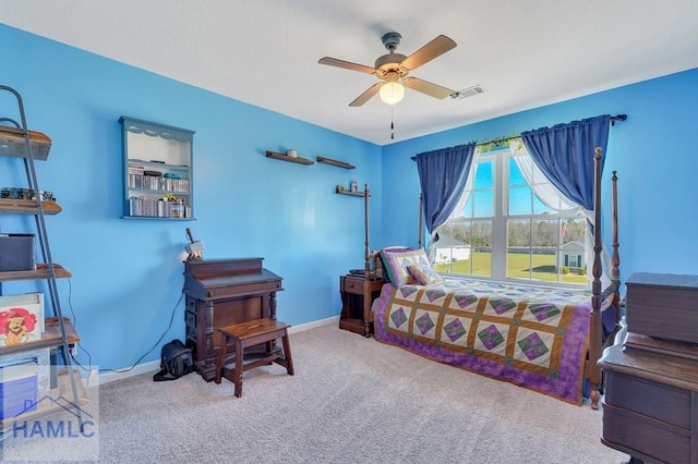 carpeted bedroom featuring baseboards, a ceiling fan, and visible vents