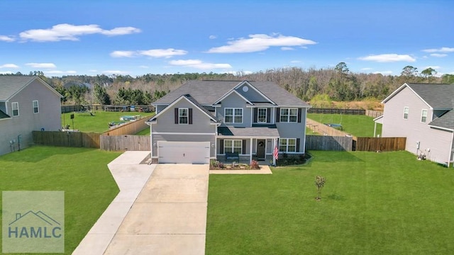 traditional home with a garage, fence, concrete driveway, and a front yard