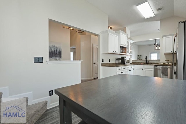 99 Scarlett Ln, Richmond Hill, GA 31324 - kitchen with appliances with stainless steel finishes, white cabinets, dark countertops, dark wood-type flooring, and lofted ceiling
