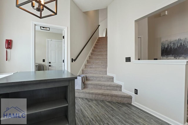 99 Scarlett Ln, Richmond Hill, GA 31324 - staircase featuring wood finished floors and a chandelier