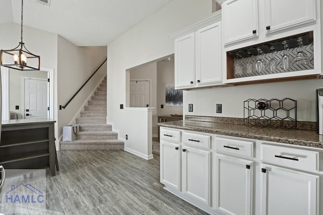 99 Scarlett Ln, Richmond Hill, GA 31324 - kitchen featuring a chandelier, white cabinetry, lofted ceiling, pendant lighting, and light wood-style flooring