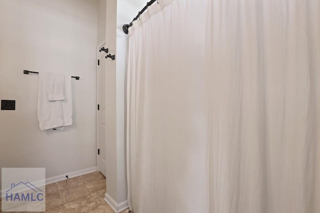 99 Scarlett Ln, Richmond Hill, GA 31324 - bathroom featuring baseboards and a shower with shower curtain