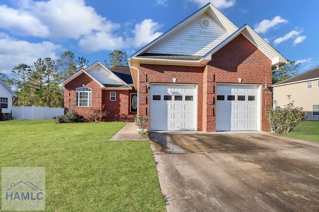 view of front facade featuring driveway, a front lawn, fence, an attached garage, and brick siding