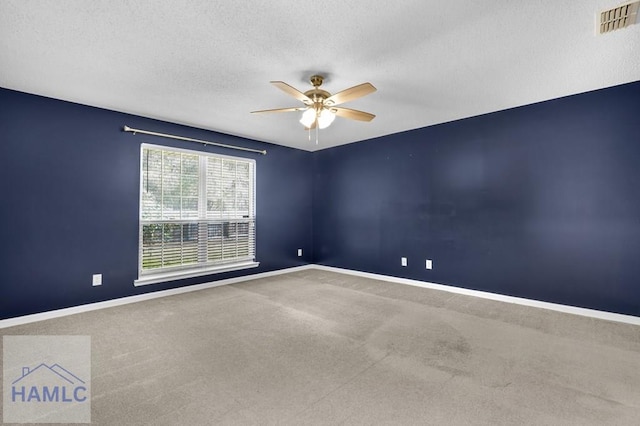 spare room with ceiling fan, carpet floors, and a textured ceiling