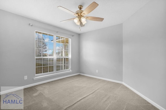 carpeted empty room featuring ceiling fan