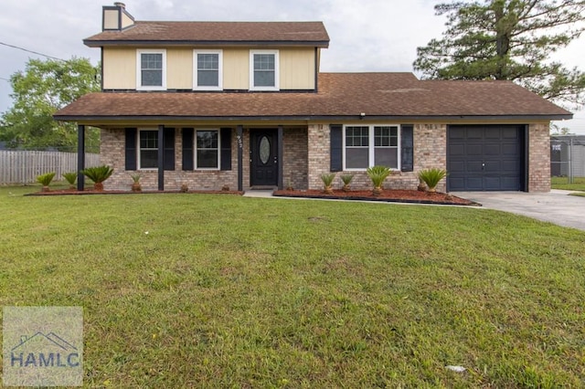 traditional home with a front yard, driveway, an attached garage, and fence