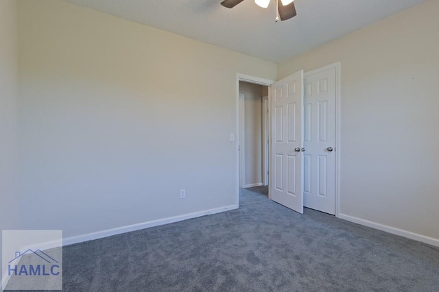 unfurnished bedroom featuring dark colored carpet, ceiling fan, and baseboards