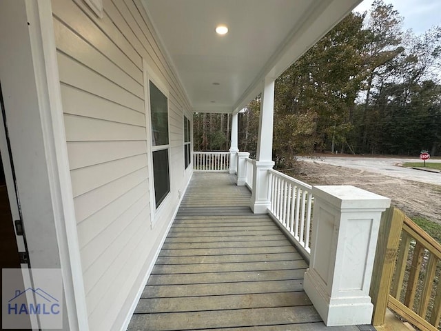 wooden terrace featuring covered porch