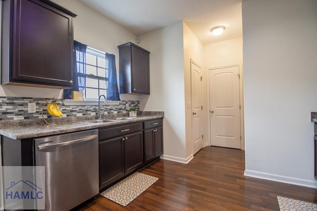 kitchen with tasteful backsplash, dishwasher, dark wood-style floors, and a sink