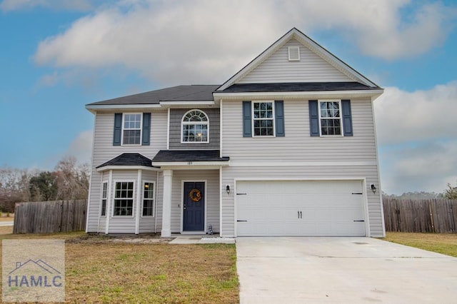 front facade featuring a garage and a front lawn