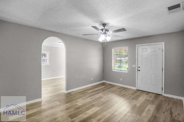 905 Greenbriar Rd, Hinesville, GA 31313 - foyer with a textured ceiling, arched walkways, ceiling fan, and baseboards