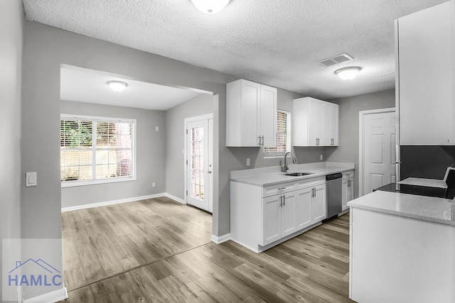905 Greenbriar Rd, Hinesville, GA 31313 - kitchen featuring a sink, stainless steel dishwasher, light countertops, white cabinets, and a textured ceiling