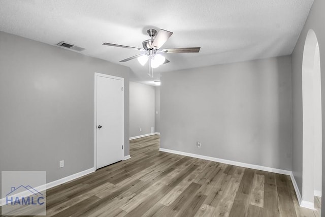 905 Greenbriar Rd, Hinesville, GA 31313 - empty room featuring a ceiling fan, wood finished floors, baseboards, and arched walkways