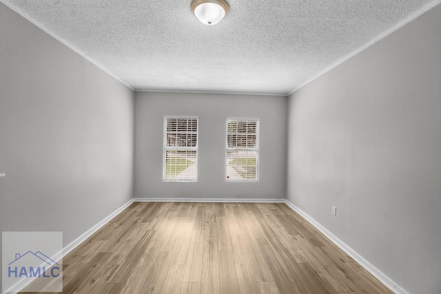 905 Greenbriar Rd, Hinesville, GA 31313 - empty room featuring a textured ceiling, wood finished floors, and baseboards
