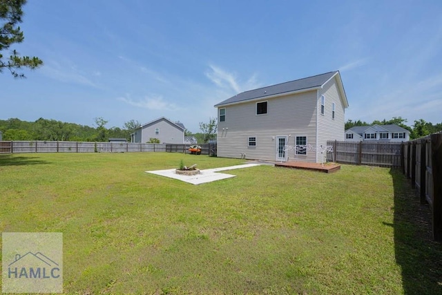 46 Covey Ln NE, Ludowici, GA 31316 - back of house featuring a fire pit and a wooden deck