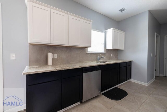 46 Covey Ln NE, Ludowici, GA 31316 - kitchen with dishwasher, a sink, tasteful backsplash, white cabinetry, and light stone counters