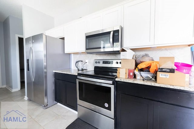 46 Covey Ln NE, Ludowici, GA 31316 - kitchen with stainless steel appliances, tasteful backsplash, and white cabinetry