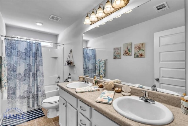 bathroom featuring toilet, a sink, and visible vents