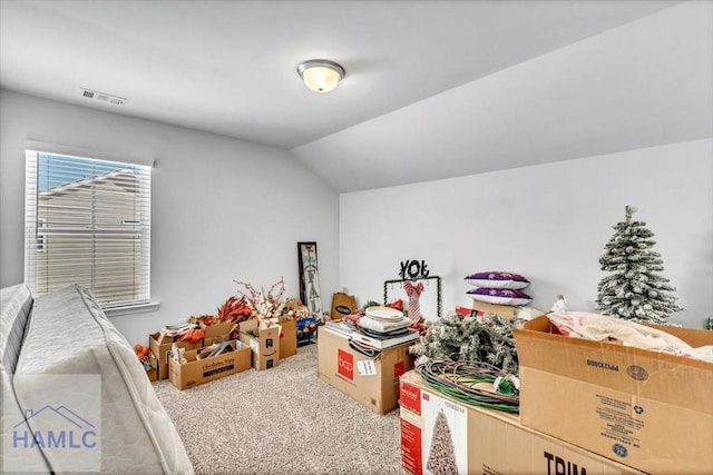 interior space featuring carpet, vaulted ceiling, and visible vents