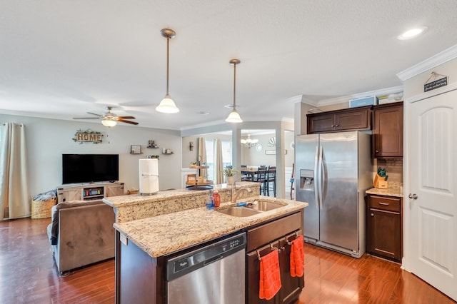 kitchen featuring sink, stainless steel appliances, dark hardwood / wood-style floors, crown molding, and a kitchen island with sink