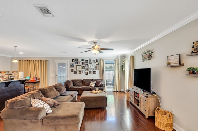 living room featuring ceiling fan, dark hardwood / wood-style floors, and ornamental molding